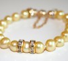 Unique yellow freshwater pearl bracelet with Swarovski bead accents and gold clasp.